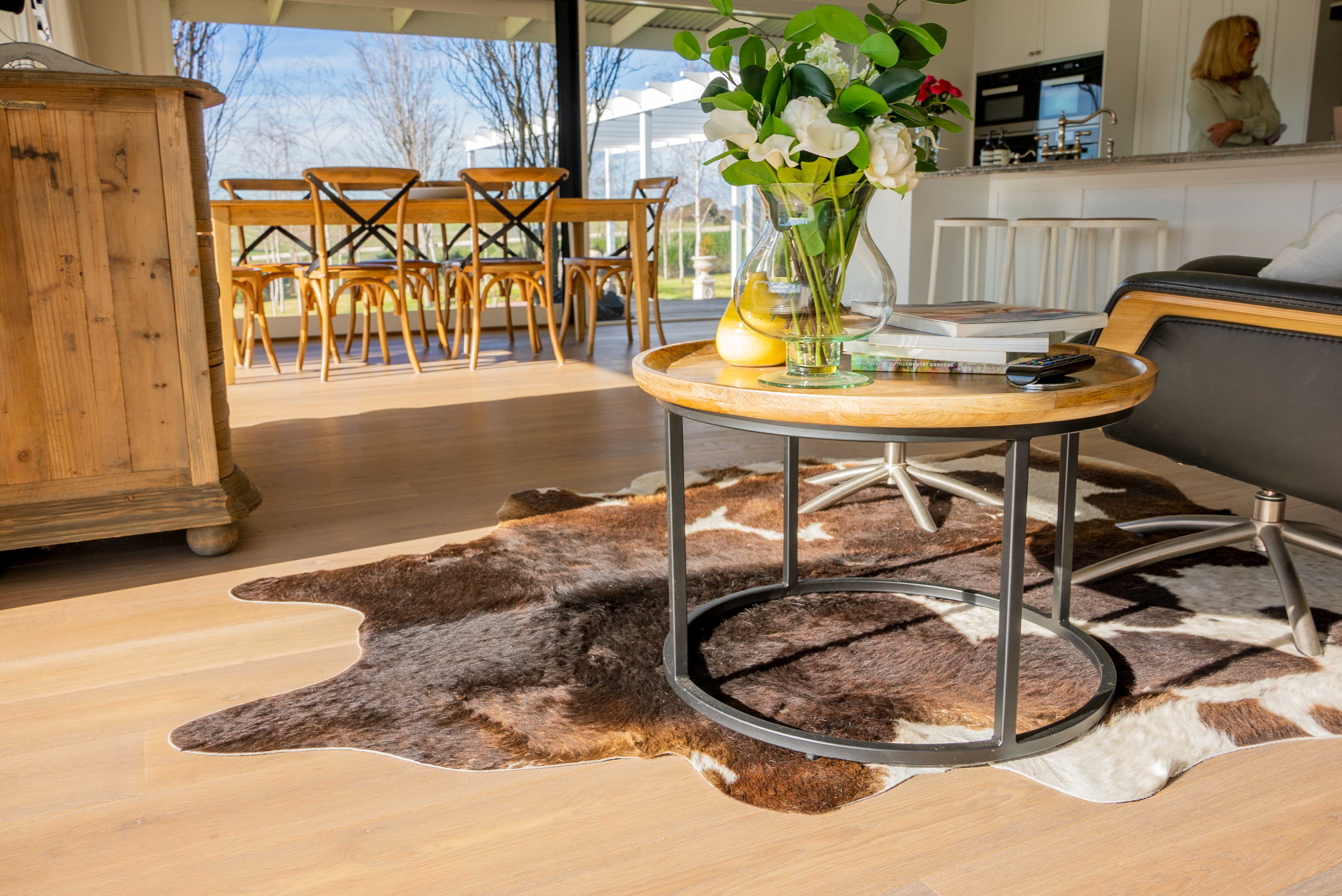 Peninsula farm residence &mdash; dining area with cowhide rug and outdoor view