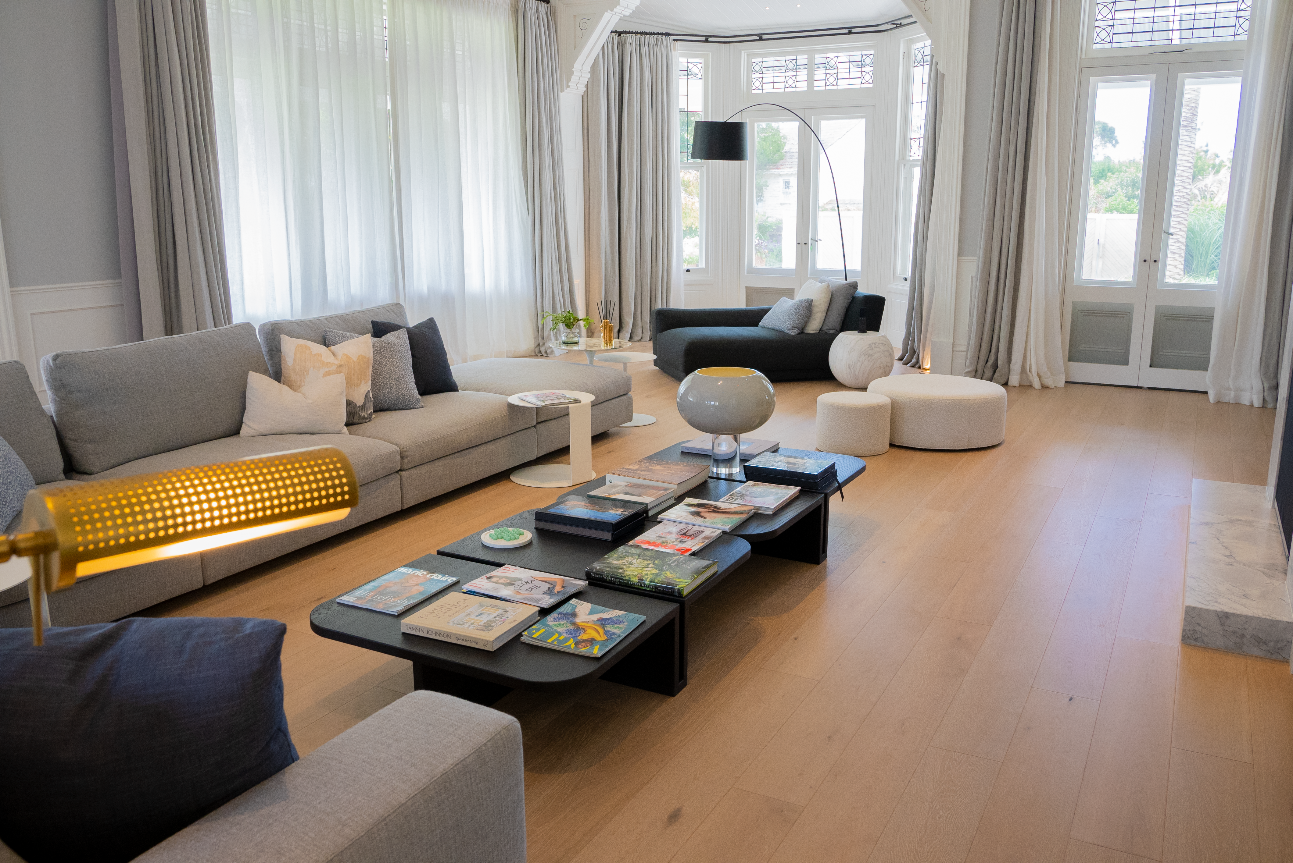Dawn House &mdash; formal living with grey sofas and bay window